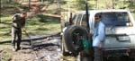 21-Laurie puts out a smoldering campfire - Heidi fetches water to help
